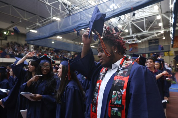 Javon Henderson (right) lifts a graduation cap of his head at the end of Class of 2024 graduation ceremony at Oak Park River Forest High School in Oak Park on Sunday, May 26, 2024. (Trent Sprague/for the Pioneer Press)