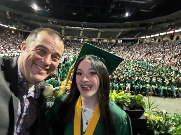 Family memory maker. From left, Bob Pinta of Prairie View, formerly of Buffalo Grove, currently a computer science teacher at Stevenson, snaps a special cell phone selfie on stage at diploma time with graduate Molly Pinta, 18, at the Adlai E. Stevenson High School Class of 2024 commencement at NOW Arena in Hoffman Estates on May 24, 2024. (Photo credit: Bob Pinta)