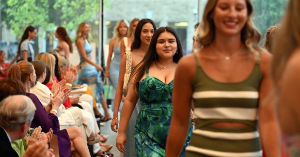 In the runway, in teal dress, is model Mariah De La Fuente of Northbrook at the 2024 Fashion Show hosted by Friends of Youth Services on June 20, 2024 at the McGrath Family Performing Arts Center at Loyola Academy (1100 Laramie Ave.) in Wilmette. (Karie Angell Luc/Pioneer Press)