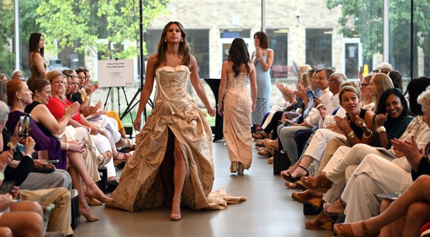 Left, model Dani Powell of Glenview, of the Loyola Academy Class of 2022, walks down the runway at the 2024 Fashion Show hosted by Friends of Youth Services on June 20, 2024 at the McGrath Family Performing Arts Center at Loyola Academy (1100 Laramie Ave.) in Wilmette. (Karie Angell Luc/Pioneer Press)