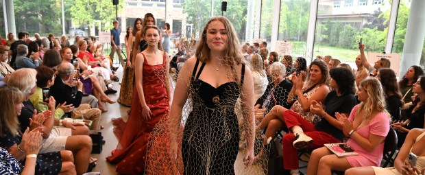 Right, in a gown with upcyled and repurposed gilded chicken wire is Bella DeRosa of Glenview, of the Glenbrook South High School Class of 2022, modeling a gown designed by sibling Nicholas De Rosa of Glenview, 18, of the Glenbrook South High School Class of 2024, at the 2024 Fashion Show hosted by Friends of Youth Services on June 20, 2024 at the McGrath Family Performing Arts Center at Loyola Academy (1100 Laramie Ave.) in Wilmette. (Karie Angell Luc/Pioneer Press)