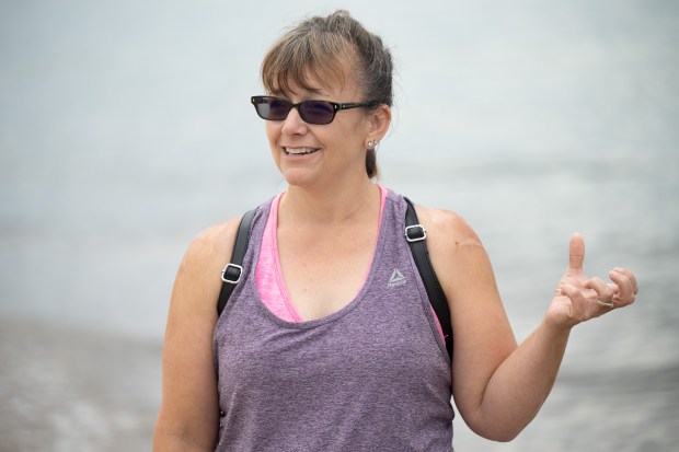 Morrison, Ill. resident Toni Trombo speaks about her experience with riptides, and how she keeps her daughters and herself safe in large bodies of water, as they spend time at Porter Beach on Wednesday, June 26, 2024. (Kyle Telechan/for the Post-Tribune)