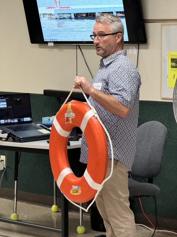 Great Lakes Surf Rescue Project Executive Director Dave Benjamin shows what a life ring looks like to members of the Aktion Club members at Opportunity Enterprises in Valparaiso on Thursday, June 27, 2024. (Doug Ross/for Post-Tribune)