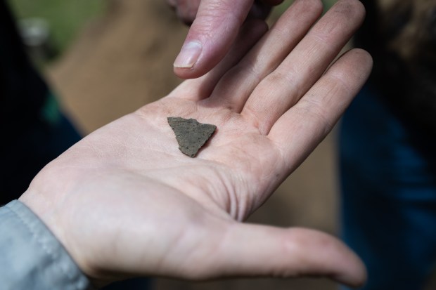 University of Notre Dame anthropology student Charlotte Cardarella holds a shard of suspected pottery in her hand, discovered during the annual Collier Lodge site archaeological dig on on Monday, June 10, 2024. (Kyle Telechan/for the Post-Tribune)