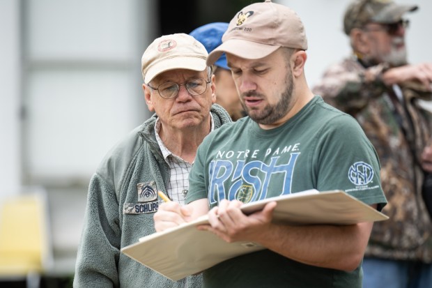 Participant Jacob Hall, on right, and University of Notre Dame anthropology Professor Mark Schurr confer over notes during the annual Collier Lodge site archaeological dig on on Monday, June 10, 2024. (Kyle Telechan/for the Post-Tribune)