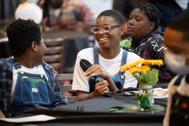 Graduate Matthew Williams holds a shovel given to him as a gift for graduating Faith Farm and Orchard's Next Urban Ag Generation program on Saturday, June 1, 2024. (Kyle Telechan/for the Post-Tribune)