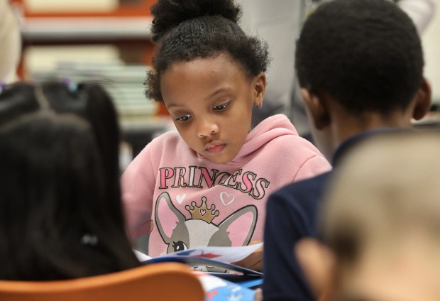 Second grader A'mei Bledsoe 7, reads a The Cat in the Hat during the 2nd Annual Mother's Day Book Give Away hosted by the School House Children Charity at Glen Park Academy in Gary on Friday, May 10, 2024. (John Smierciak/for the Post Tribune)