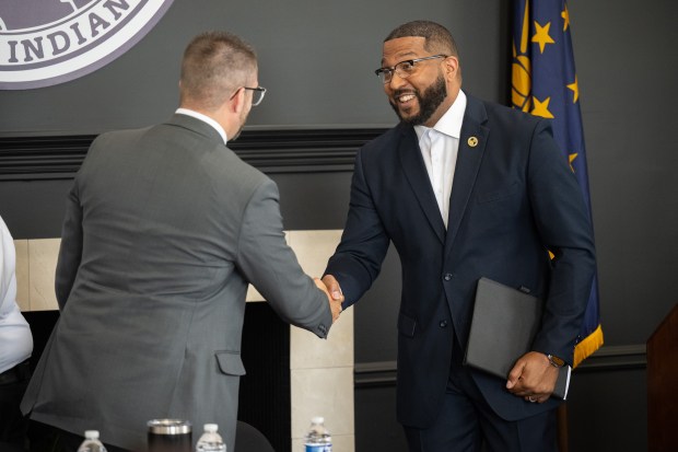 Gary mayor Eddie Melton, on left, shakes hands with IDEM commissioner Brian Rockensuess after a press conference to announce a program to curb illegal dumping in the city on Tuesday, June 4, 2024. (Kyle Telechan/for the Post-Tribune)