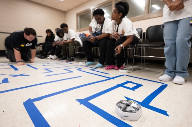 A robot programmed to run a maze by local students navigates a corner as part of a session at the Best Buy Geek Squad Academy event at Indiana University Northwest on Thursday, June 13, 2024. (Kyle Telechan/for the Post-Tribune)