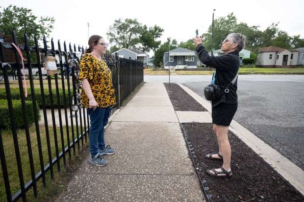 Gary resident Gloria Fallon, on right, takes a picture of her daughter-in-law Candice Fallon, visiting from Australia, outside of Michael Jackson's childhood home on the fifteenth anniversary of the King of Pop's death on Tuesday, June 25, 2024. (Kyle Telechan/for the Post-Tribune)
