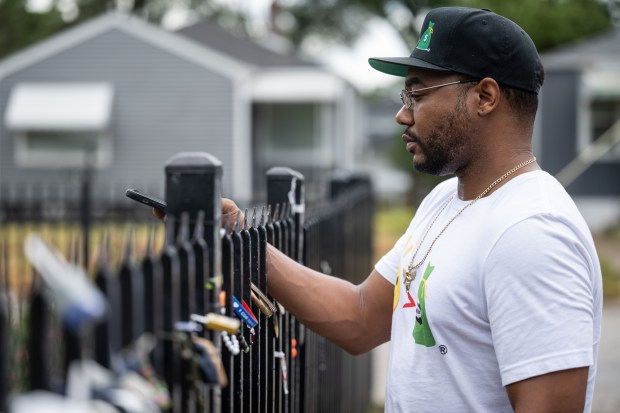 Chicago resident and real estate investor Andre Haynes takes a photo of a plaque outside of Michael Jackson's childhood home on the fifteenth anniversary of the King of Pop's death on Tuesday, June 25, 2024. (Kyle Telechan/for the Post-Tribune)