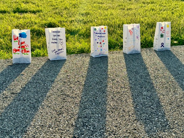 Luminaria line the walkway at Haven Hollow Park in South Haven, lighting the way for people walking to promote awareness for suicide prevention and mental health. (Doug Ross/Post-Tribune)