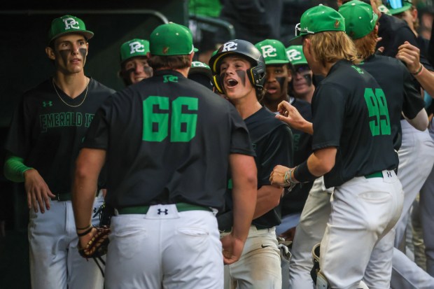 Providence's Mitch Voltz (27) celebrates with his teammates after scoring a run during the Class 4A State Championship game against Conant in Joliet on Saturday, June 8, 2024. (Troy Stolt/for the Daily Southtown)