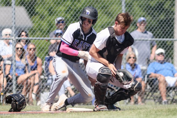 Lincoln-Way Central's Braden Meyer (4) catches a throw to home as Lincoln-Way East's Tyler Bell (6) scores a run during the Class 4A Lincoln-Way Central Regional final in New Lenox on Saturday, May 25, 2024. (Troy Stolt/for the Daily Southtown)