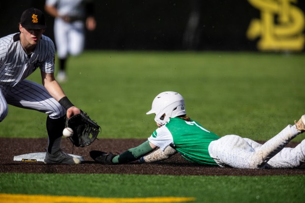 St. Laurence's Cory Les catches a ball for a force out of Providence's Nolan Galla at second base during a Chicago Catholic League Blue game in Burbank on Tuesday, April 23, 2024. (Vincent D. Johnson/for the Daily Southtown)