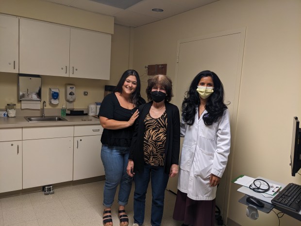 Oak Forest resident Michelle Knight, center, stands with her daughter Francesca Agostinelli and transplant pulmonologist Dr. Mrinalini Venkata Subramani during a followup visit at Northwestern Medicine Palos Hospital's new Lung Transplant Clinic. Knight was the recipient of a lifesaving double lung transplant. (Janice Neumann/Daily Southtown)