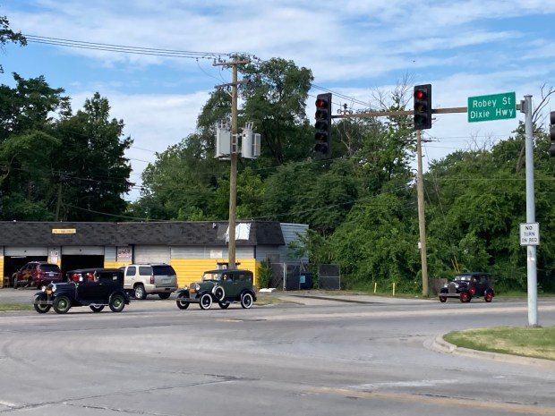 Classic Model A Ford cars turn onto Dixie Highway 167th Street in Markham on Saturday, June 22, 2024, as part of the Day on the Dixie tour from Markham to St. Anne, with several stops along the way. (Paul Eisenberg/Daily Southtown)