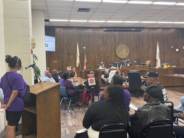 Harvey business owner Benecia Gonzalez, 24, addresses the City Council over orders to close her auto shop due to overdue property taxes. (Samantha Moilanen/Daily Southtown)