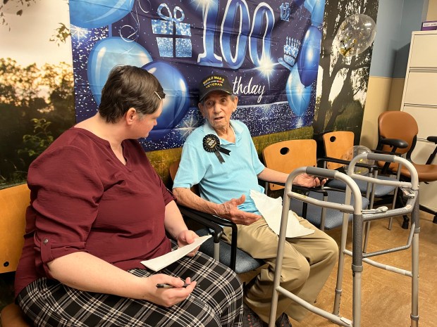 World War II veteran Lawrence Szydlowski answers questions about his life from VA public affairs specialist Debralee Lutgen. (Olivia Stevens/Daily Southtown)