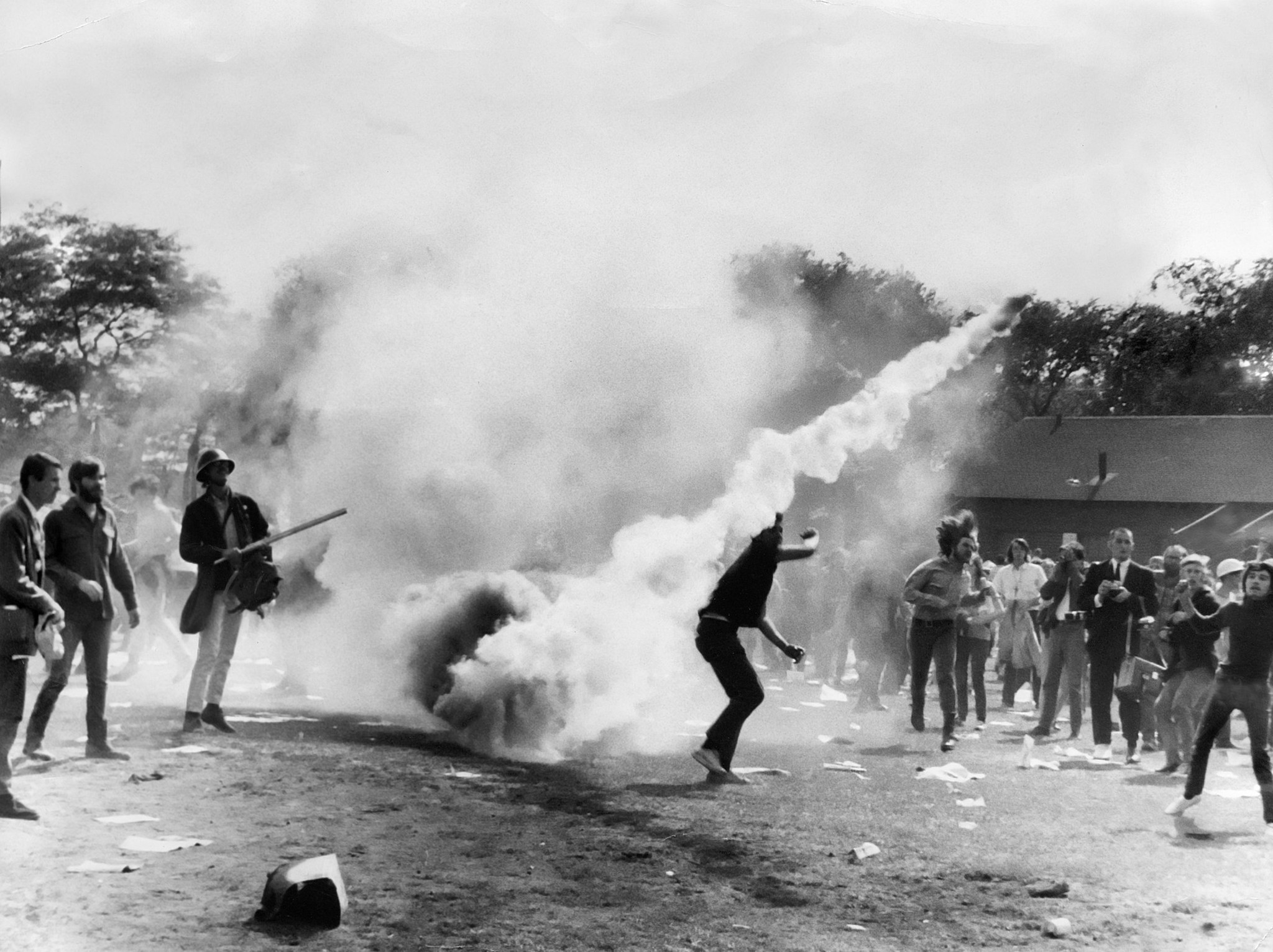 Protesters lob back tear gas canisters thrown by Chicago police...