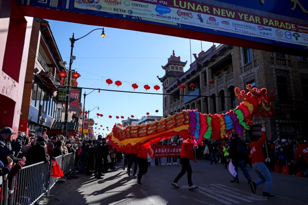 People perform a dragon dance as they march in the Lunar New Year Parade in Chinatown on Feb. 18, 2024. (Eileen T. Meslar/Chicago Tribune)