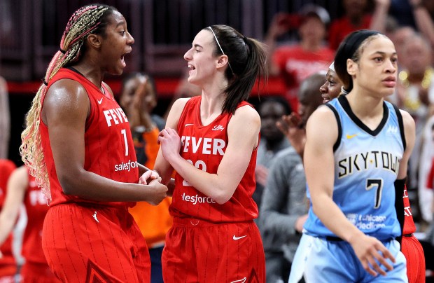 Indiana Fever players Aliyah Boston, from left, and Caitlin Clark celebrate after defeating the Chicago Sky on June 1, 2024, in Indianapolis. At right is Sky guard Chennedy Carter. (Andy Lyons/Getty)