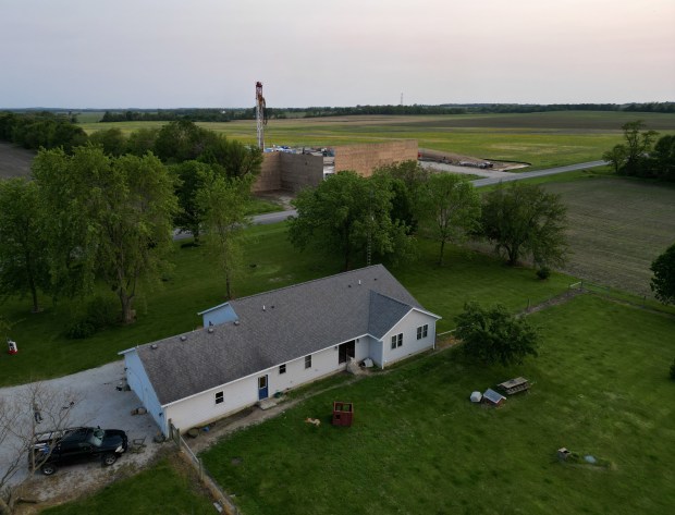 The home of Ralph and Sabrina Jones and their children, left, and a Navigator CO2 drilling site sit about 50 yards from each other on May 18, 2023 in rural Nokomis. (Stacey Wescott/Chicago Tribune)