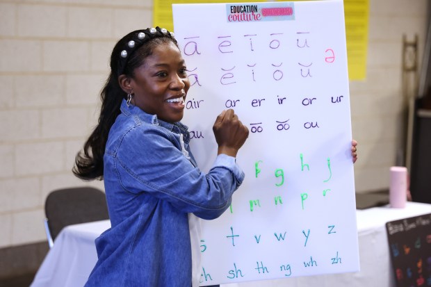 Ruckiya Ross, founder of Education Couture, leads a workshop at Chicago's Garfield Park Conservatory on May 29, 2024, teaching children to read and pronounce vowels. (Terrence Antonio James/Chicago Tribune)