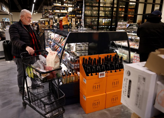 Bruce Albert shops at Dom's Kitchen & Market in Chicago's Lincoln Park neighborhood on Dec. 21, 2022. (Chris Sweda/Chicago Tribune)