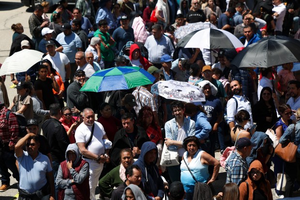 Mexican nationals line up outside in a parking lot next to the Consulate General of Mexico in Chicago to vote in the Mexican presidential election on June 2, 2024. (Eileen T. Meslar/Chicago Tribune)