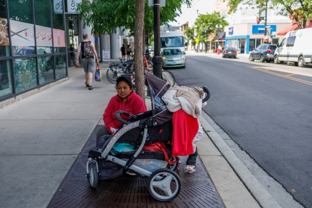 Jessica Juma sits on the street where her husband, Angel Mashiant, went missing on May 25 in an alley near a Mariano's in Lakeview, June 3, 2024. (Armando L. Sanchez/Chicago Tribune)