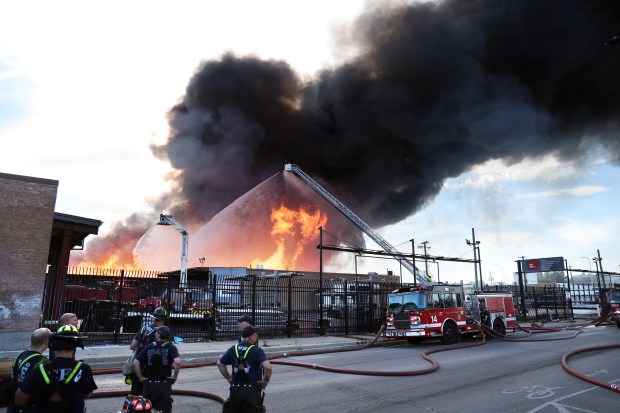 Chicago Fire Department firefighters battle a massive blaze at a pallet yard in the 2000 block of W. Hubbard Street in Chicago on June 18, 2024. (Terrence Antonio James/Chicago Tribune)