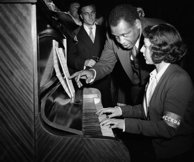 Singer Paul Robeson confers with accompanist Helen Thierry before singing in Spanish, Russian and English to the delegates of the Congress of Partisans of Peace at the Salle Pleyel in Paris, April 20, 1949. (Jean-Jacques Levy/AP)