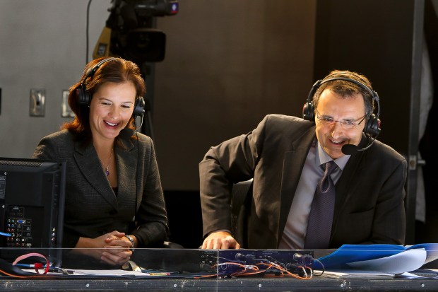 "Hockey Night in Canada" broadcaster Rick Ball, right, calls play-by-play action between the Jets and the Stars alongside color commentator Cassie Campbell-Pascall on Dec. 14, 2013, in Winnipeg, Manitoba. (Jonathan Kozub/Getty Images)