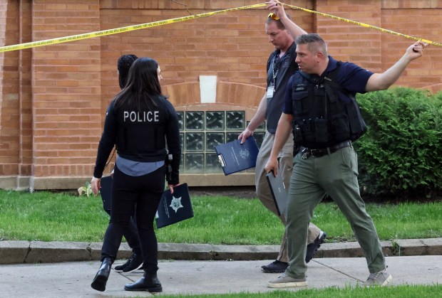 Chicago police detectives work a crime scene in the 7700 block of South Throop Street on May 20, 2024. The body of a reported gunshot victim was found in a vacant residential building there. (Terrence Antonio James/Chicago Tribune)