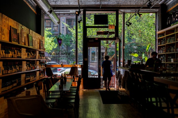 A person walks through the door at the Printers Row Wine Bar and Shop on June 16, 2024. (Armando L. Sanchez/Chicago Tribune)