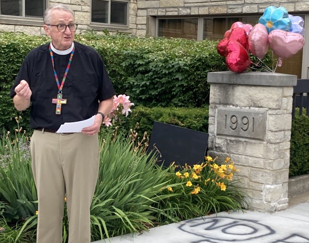 The Rev. Mark Rollenhagen talks to a crowd of more than 100 people Sunday during a service following vandalism at the church last week. (Steve Sadin/For the Lake County News-Sun)