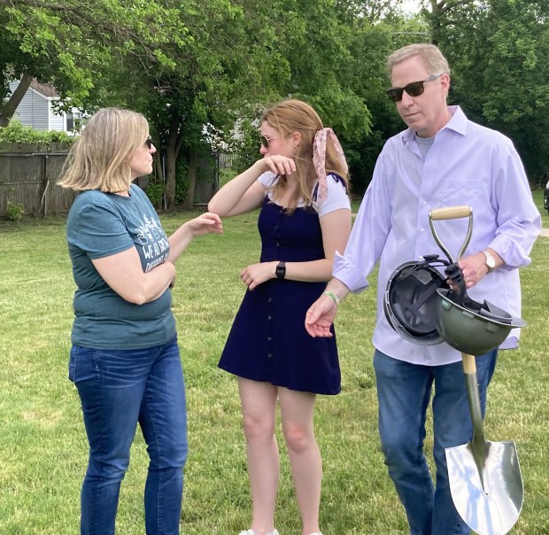 Family members, from left, Tarali, Allison and Michael Schaumberger, take a moment alone after the groundbreaking Thursday. (Steve Sadin/For the Lake County News-Sun)