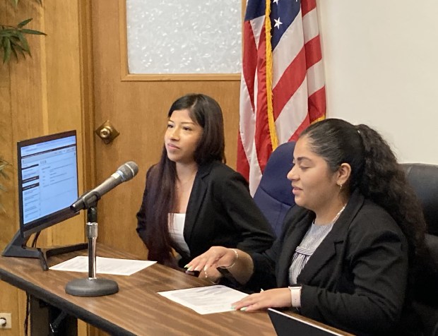 Melanie Fernandez Rosales, left, and Brianna Bravo listen after taking their seats as student members on Waukegan Community Unit School District 60 Board of Education (Steve Sadin/For the Lake County News-Sun)