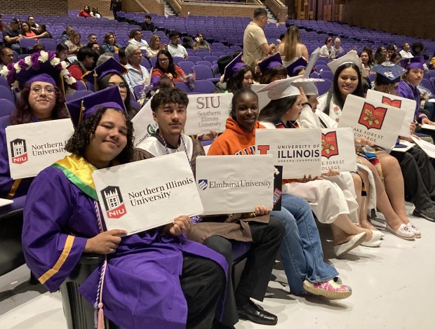 Waukegan to College high school seniors hold signs showing where they plan to go to school next year. (Steve Sadin/For the Lake County News-Sun)