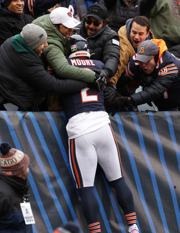 Chicago Bears wide receiver DJ Moore (2) celebrates with fans after rushing for a touchdown against the Detroit Lions in the first quarter at Soldier Field on Dec. 10, 2023, in Chicago. (John J. Kim/Chicago Tribune)