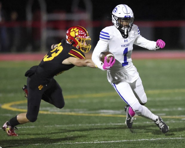 Geneva's Talyn Taylor (1) slips past Batavia's Drake Ostrander (23) for a first down during a DuKane Conference game in Batavia on Friday, Oct. 7, 2022.