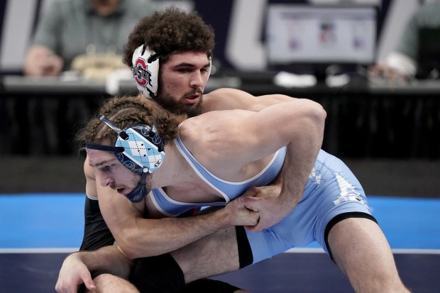 North Carolina's Austin O'Connor, right, tries to maneuver around Ohio State's Sammy Sasso during the 149-pound championship match of the NCAA Tournament in St. Louis on Saturday, March 20, 2021.