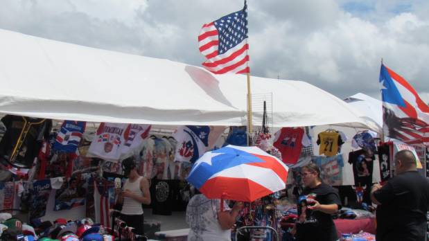 Booths offered a variety of Puerto Rican merchandise at the 52nd Aurora Puerto Rican Heritage Festival Sunday in downtown Aurora. (Linda Girardi / For The Beacon-News)