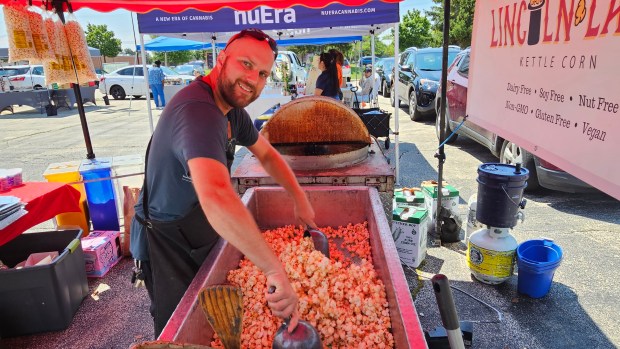 Arthur Wright makes a batch of Lincoln Land Kettle Corn on Wednesday at the midweek Aurora Farmers Market on the West Side of Aurora. (David Sharos / For The Beacon-News)