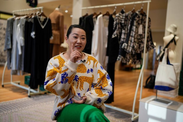 Zhang Na, whose fashion label, Reclothing Bank, sells clothes, bags and other accessories made from materials such as plastic bottles, fishing nets and flour sacks, speaks during an interview at her store in Shanghai on March 19, 2024. (AP Photo/Ng Han Guan)