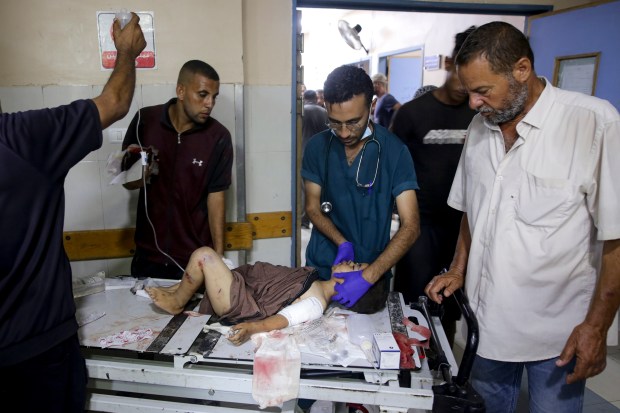 A Palestinian boy wounded in the Israeli bombardment of the Gaza Strip is treated in a hospital in Khan Younis, Tuesday, July 9, 2024. (AP Photo/Jehad Alshrafi)