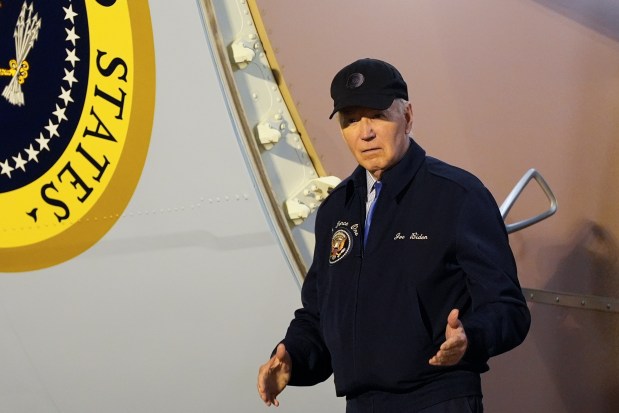 President Joe Biden walks down the steps of Air Force One at Dover Air Force Base in Delaware, Wednesday, July 17, 2024. Biden is returning to his home in Rehoboth Beach, Del., to self-isolate after testing positive for COVID-19. (AP Photo/Susan Walsh)