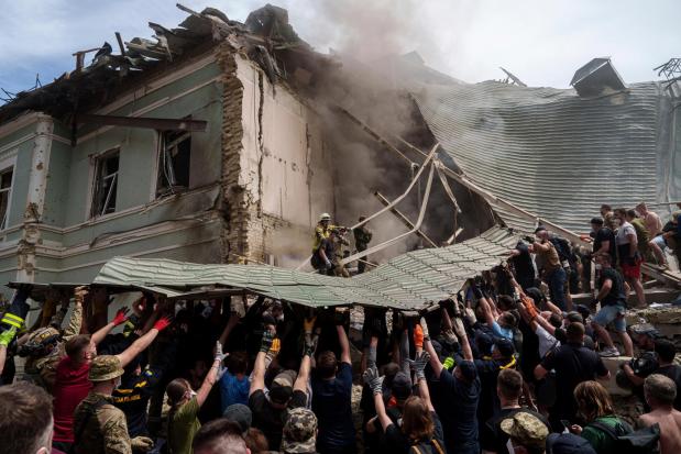 Emergency services work at the site of Okhmatdyt children's hospital hit by Russian missiles, in Kyiv, Ukraine, Monday, July 8, 2024. Russian missiles have killed several people and struck a children's hospital in the Ukrainian capital, Kyiv, authorities say. (AP Photo/Evgeniy Maloletka)