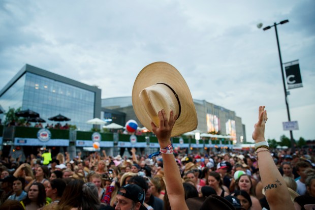 Courtney Henderson holds up her hat while waiting for Miranda Lambert to perform during the final day of the Windy City Smokeout festival outside the United Center Sunday Aug. 7, 2022 in Chicago. (Armando L. Sanchez/Chicago Tribune)